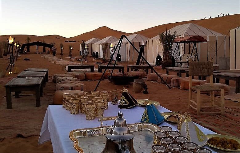 Merzouga desert camp with traditional Berber tents at sunset